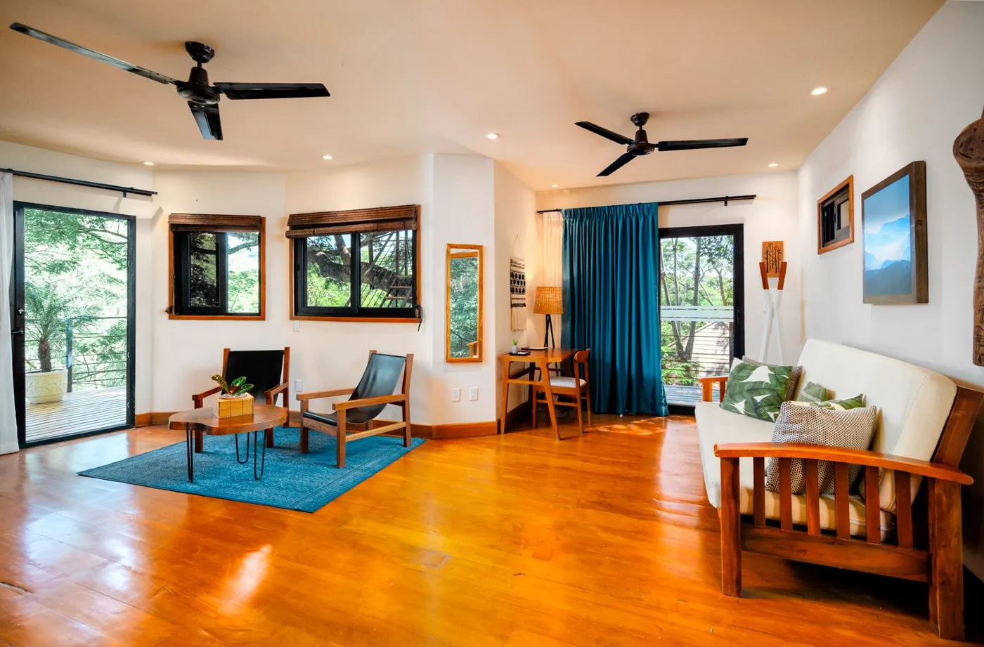 Casa Árbol at TreeCasa — two-story treehouse with thatched ceiling and ceiba views